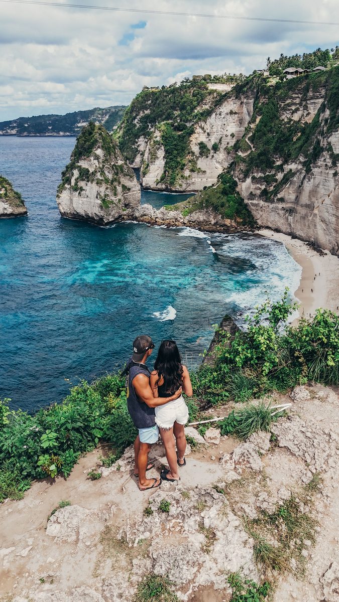 Couple overlooking a cliff and ocean